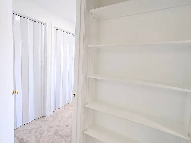 Custom-made shelves in the hall between the two bedrooms