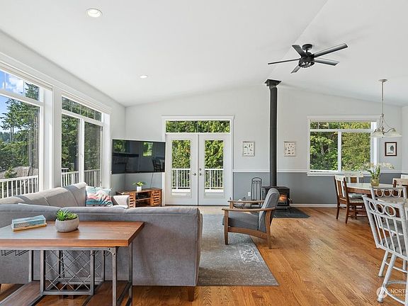Light-filled main room with smart TV and fireplace.