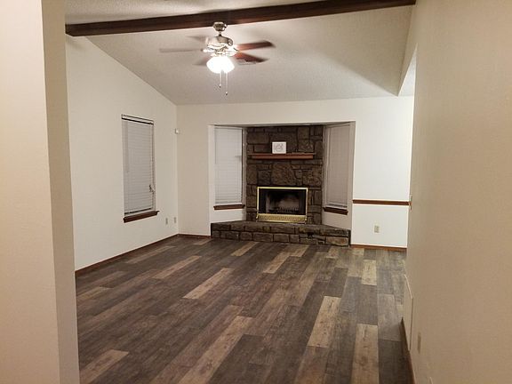New plank flooring in family room looking toward fire place