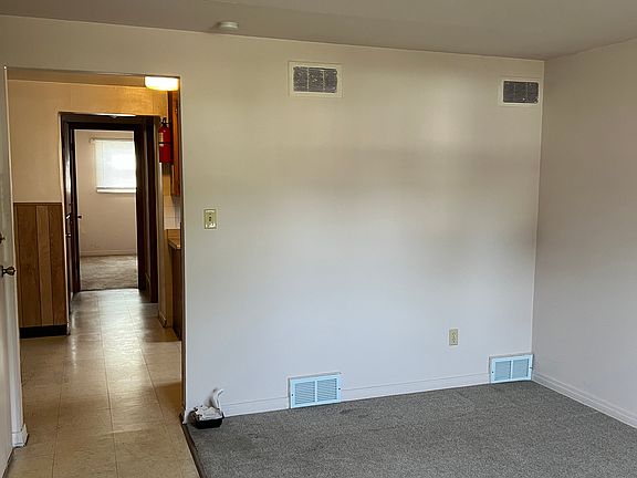 Living room, kitchen and way to bedroom