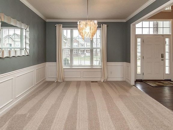 Stunning light fixture in this formal Dining Room!