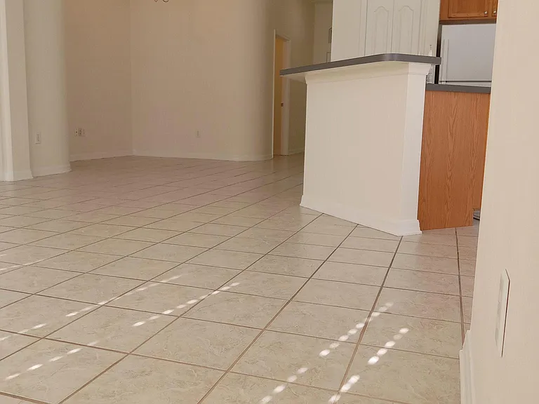 View from living room area. The kitchen is to the right. Dining area is under the light fixture to the left.