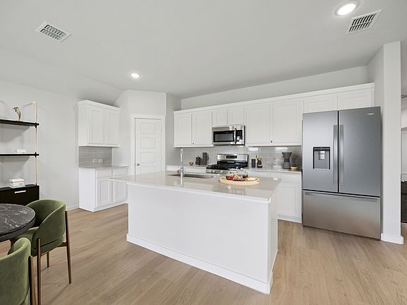Kitchen in the Hadley home plan by Trophy Signature Homes - REPRESENTATIVE PHOTO