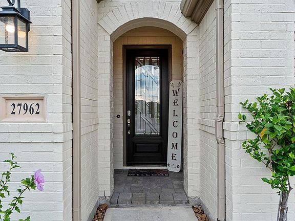 Covered porch and beautiful door make a welcoming place to greet guests.