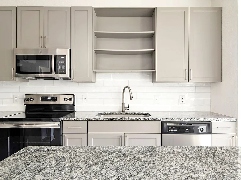 Sleek Granite Countertops and Stainless Steel Appliances