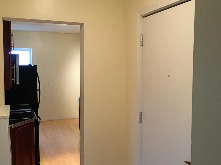 Hallway loooking at front door and kitchen/breakfast area