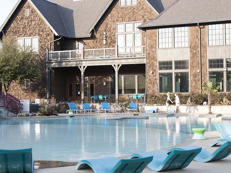 Experience ultimate comfort and style at this luxury apartment complex with a stunning poolside view.