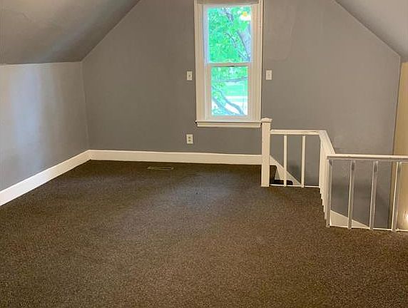 Upstairs loft common space adjacent to an upstairs bedroom and bathroom.