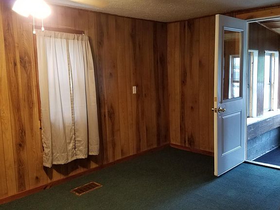 Dining room, viewing south. One window, wall to wall carpet, ceiling fan with light.