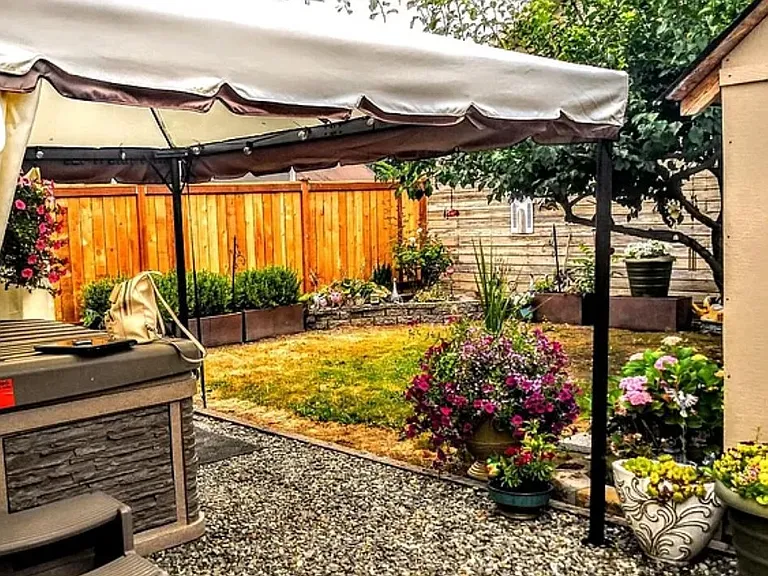 Photo taken in the spring canop included but hot tub will be removed. great fenced in backyard for private Barb B Ques.