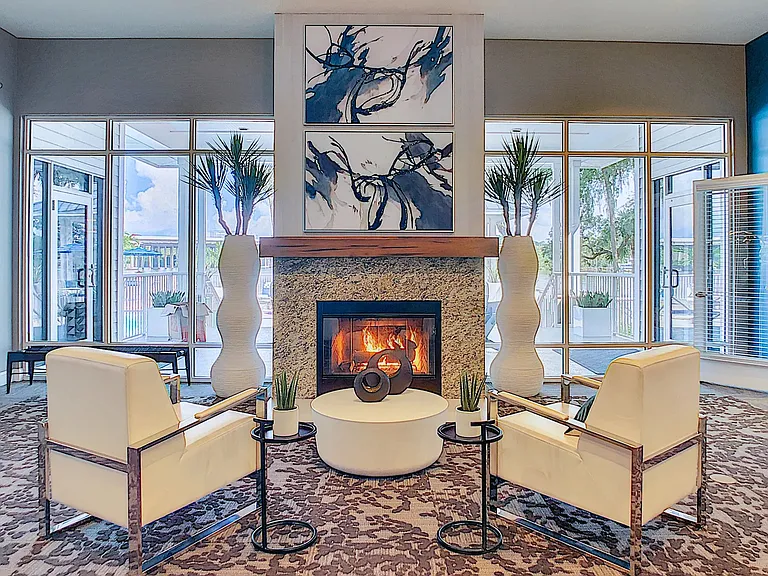 Find solace by the clubhouse fireplace in a serene setting, inviting residents to reflect and unwind in elegance.