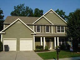 Cement sided two story home with country front porch and culdesac lot
