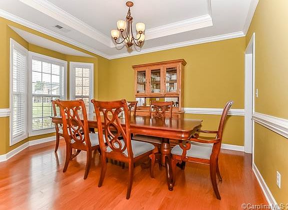 Elegant formal dining room with bay window.