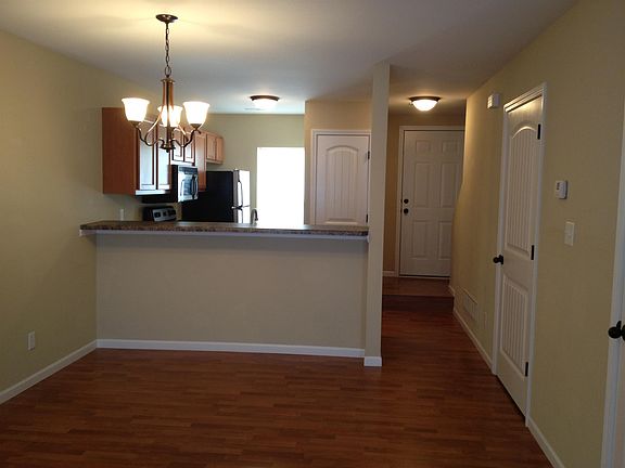 Living room - view toward kitchen and front entry door