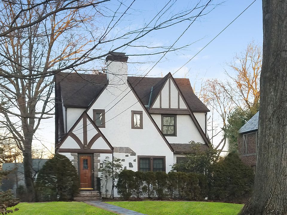 TUDOR TREASURE with many updates! HEATED 2 car garage - private driveway