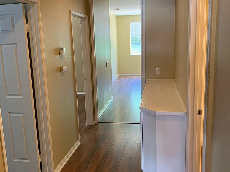 Hallway, master bedroom is on the farthest end, 2 doors on the left is entrance to the 2nd and 3rd bedroom, door on right is the hallway bathroom.