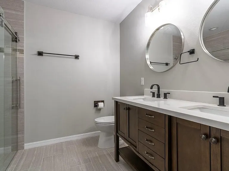 Beautifully designed bathrooms, double vanity sinks, glass shower