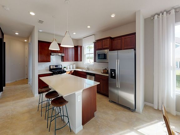 Model Representation Kitchen with stainless steel appliances and quartz countertops