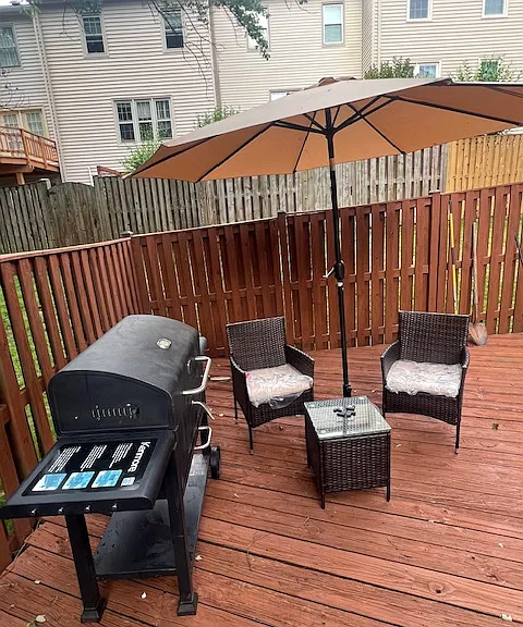 Fenced private deck with furniture and grill