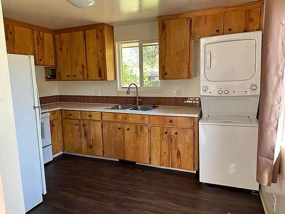 Kitchen with new oven, faucet, garbage disposal and washer/dryer. Refrigerator is very clean.