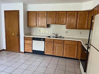 Kitchen with pantry, dishwasher, refrigerator and stove