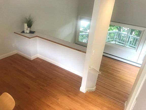 Views to Dining Room and Step Down to Living Room with Views of Nature on Private Wrap-Around Deck