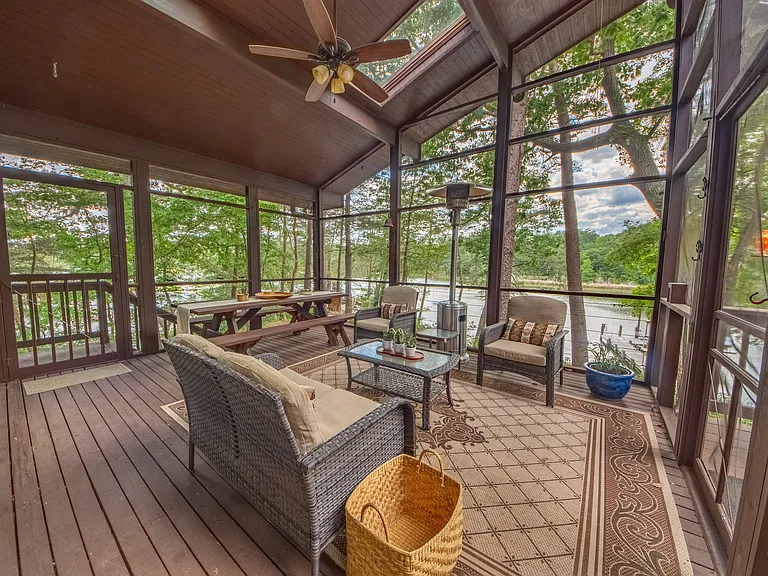 Screened porch overlooking water front.