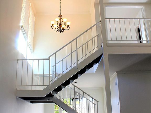 Stunning 20 ft high entrance hall and open-air staircase lea