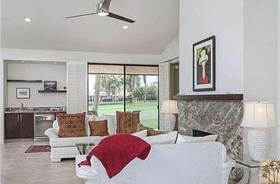 Living area with view of wet bar with refrigerator