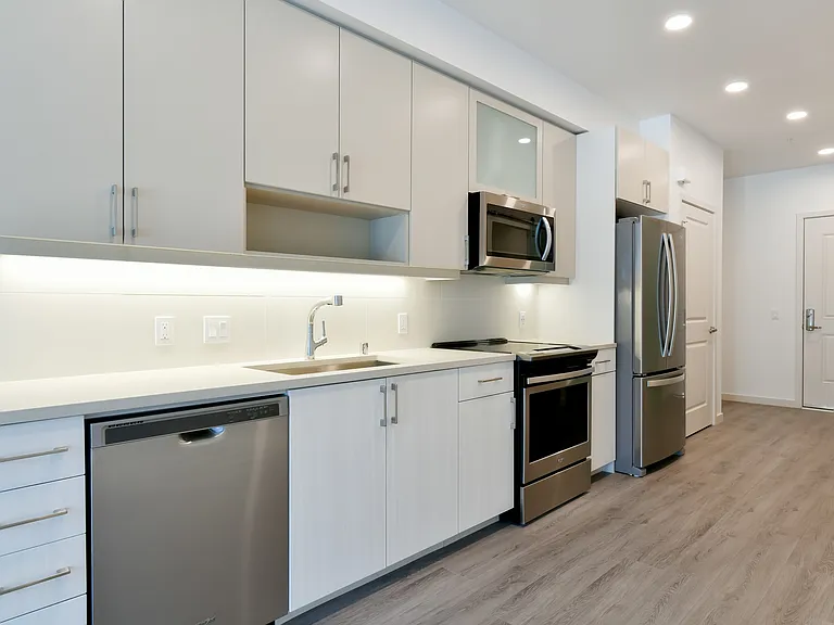 Luxe finishes and features throughout, including Whirlpool appliances and a full-height backsplash.