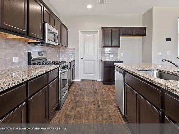 Beautiful kitchen. Note: This is photo of a model home with similar layout. This home has quartz countertop.