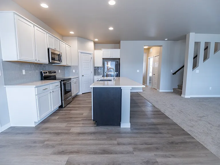Layout is open concept kitchen, dining and living room areas. Refrigerator is included with rental.