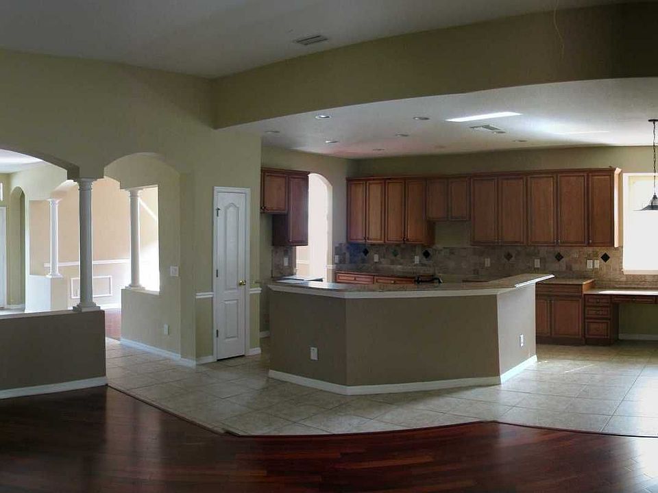 Kitchen features wood cabinets & granite