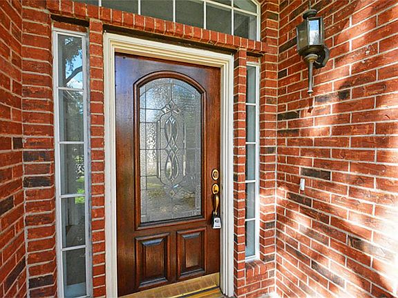 Recently varnished 1/2 lite solid wood door welcomes your guests!