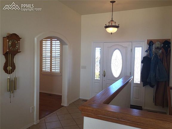 Beautiful entry way with formal dining room through the arch to the left.