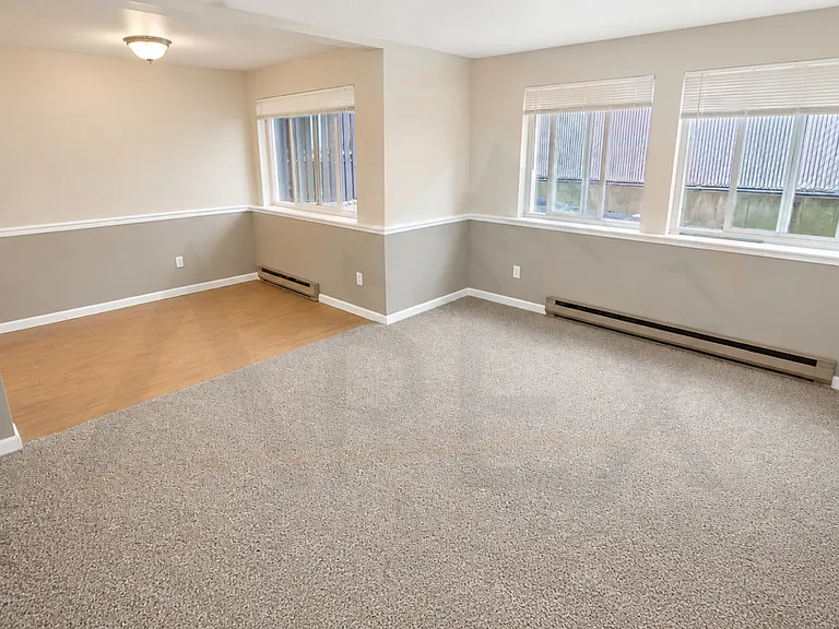 Large windows bring in natural light, creating an open and inviting feel throughout the living space.