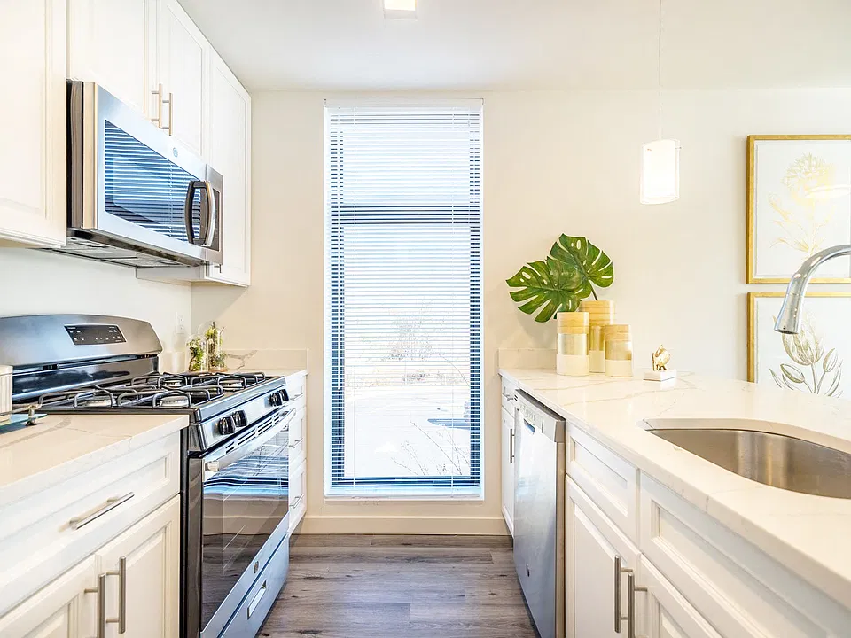 White Cabinets with brushed nickel pulls and Stainless Steel Appliance Package