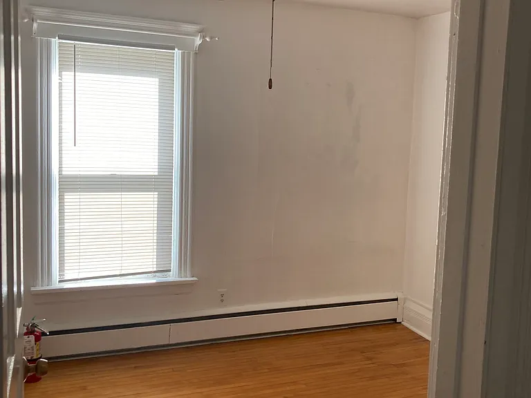 1st bedroom with wood floors