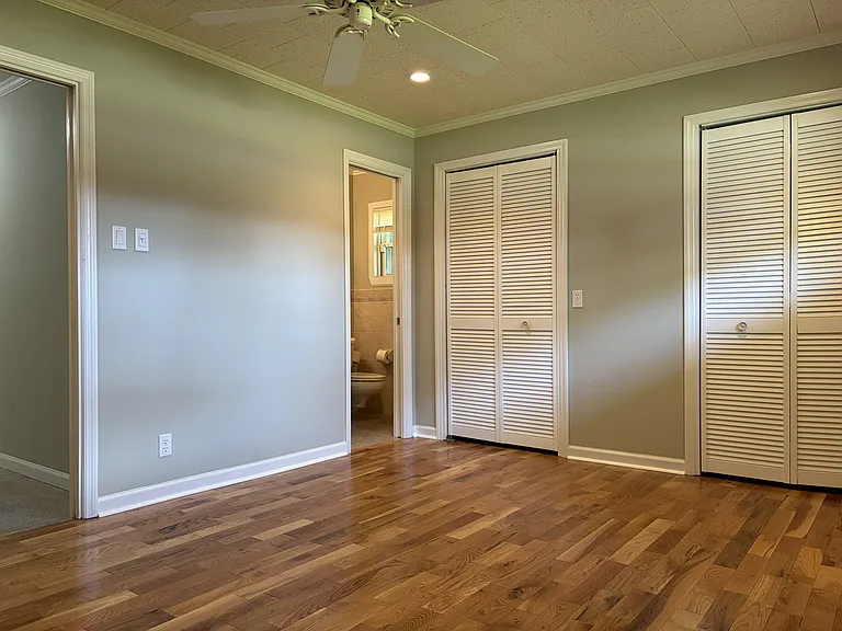 Secondary bedroom with its own private full bathroom, offering added comfort and convenience for guests or family members.