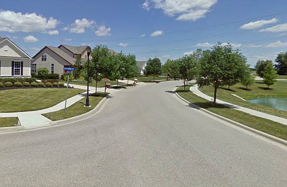 Street view, house is on left, pond on right