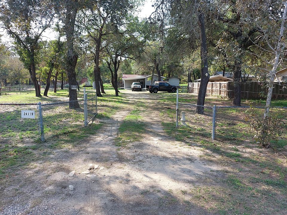 This photo gives you a good reference as to how large the fenced in lot actually is and how far back the house sits from Romin Rd. The large trees add to the enrichment of the property and very beneficial to the lot..