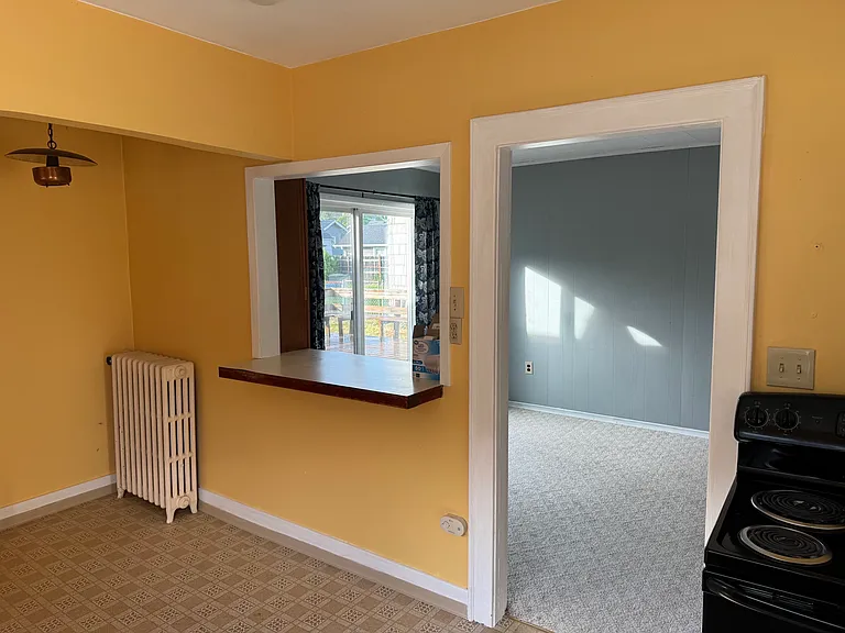 Looking from the sunny kitchen into the breakfast nook and bonus room.