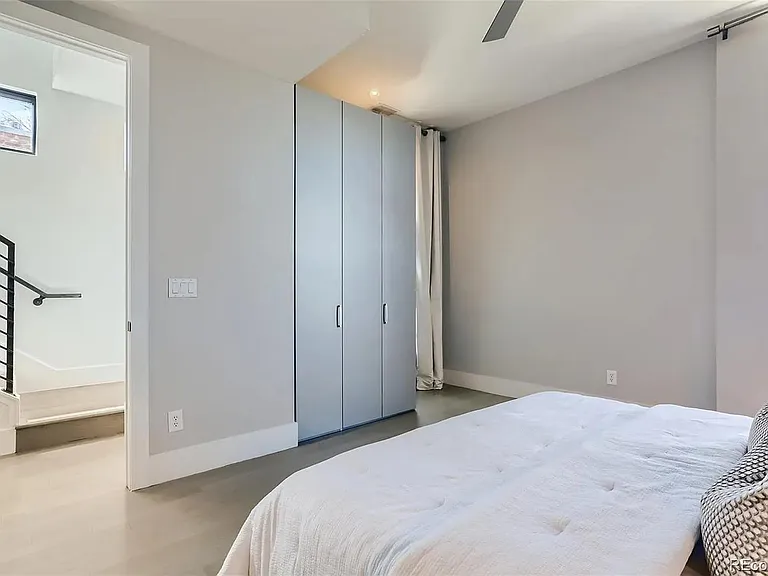 Looking back at entrance to primary bedroom and armoire for additional storage