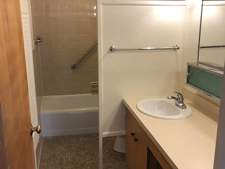 Bathroom with new countertop, sink, and faucet.