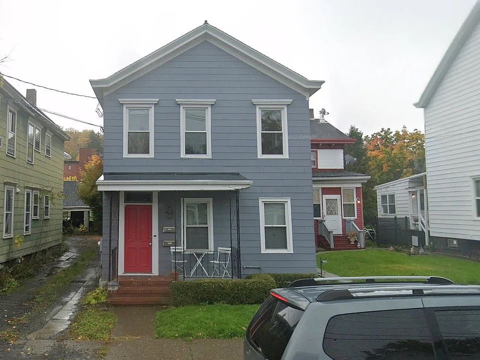 Front exterior, including porch with table and chairs
