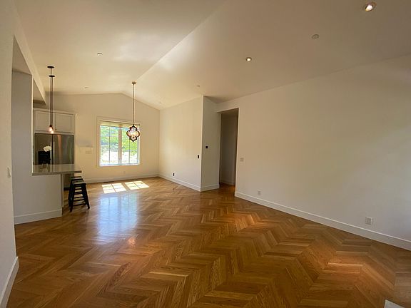Large Great Room with vaulted ceilings and hardwood floors