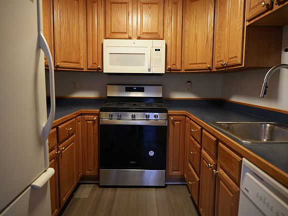 small kitchen with gas range, dishwasher, garbage disposal
