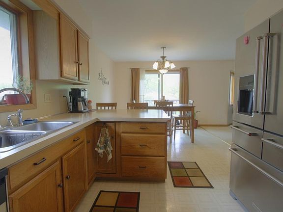 Kitchen breakfast bar and SS refrigerator.