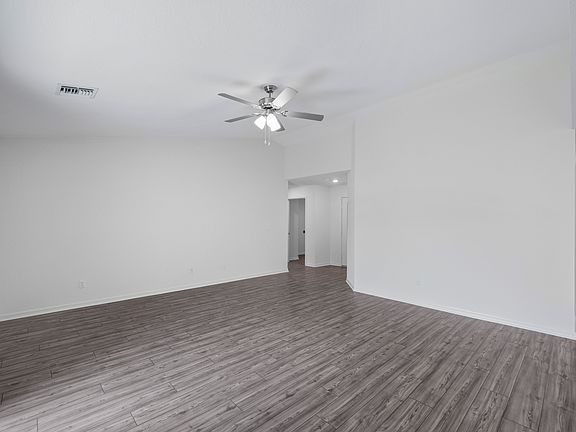 The family room is spacious and has a sliding door to the backyard