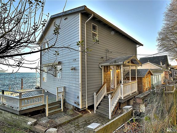 View of the front of the home featuring covered front deck and storage shed. 